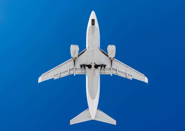 Medium,Size,White,Passenger,Airplane,On,A,Blue,Sky,Background.